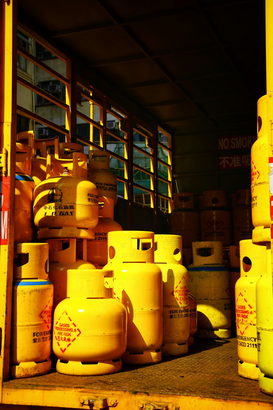 Yellow LPG cylinders stacked inside a delivery truck